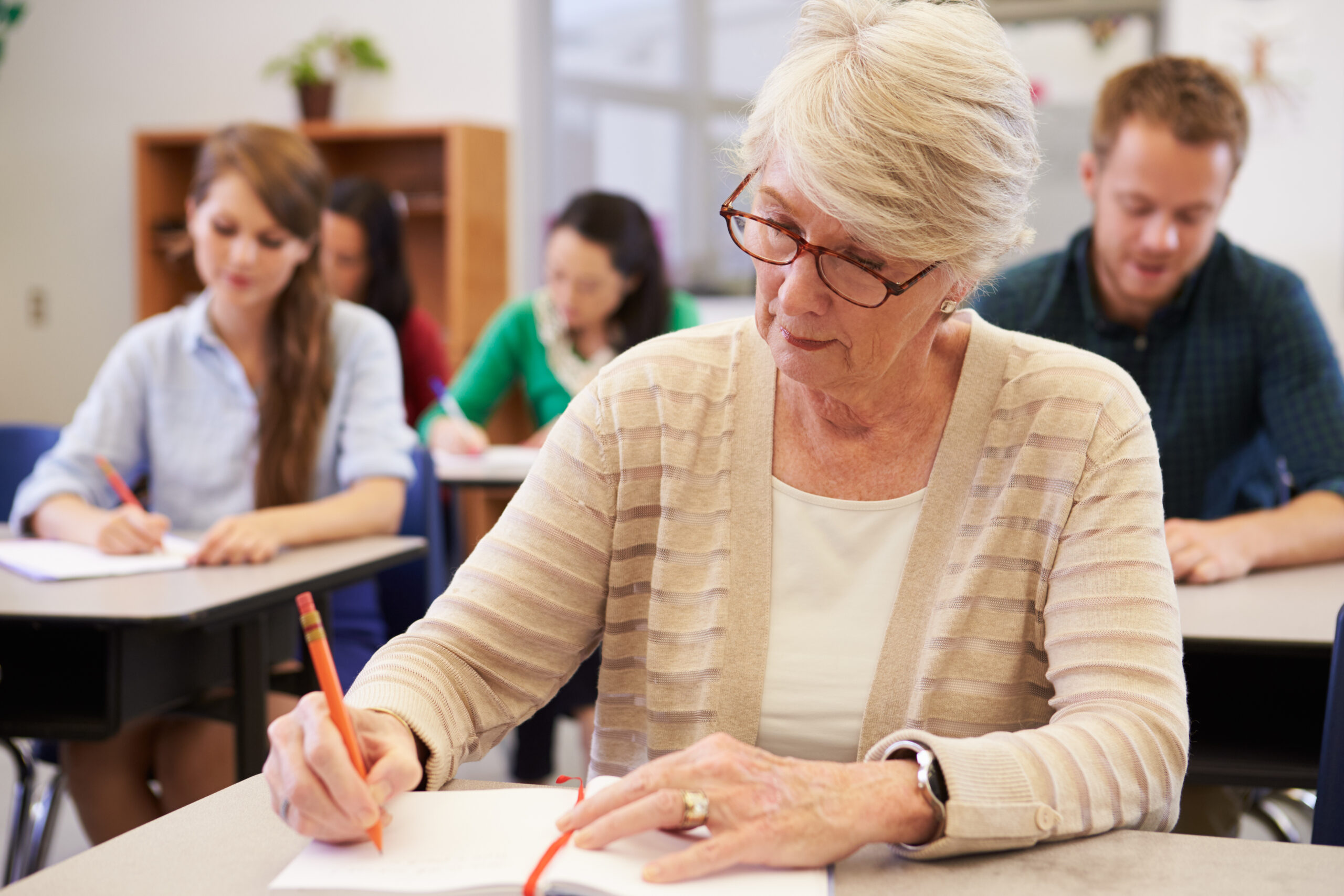 Senior woman leaning at an adult aged care education session
